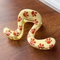 Cream yellow hair claw clip with orange paw print pattern and wavy geometric design - Yellow
