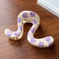 Chic cream hair claw clip with purple paw prints in a unique wavy S-shaped design - Beige