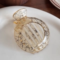 Amber resin hair claw clip with black ink lines in a minimalist round design - Beige