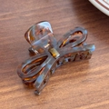 Elegant 3D butterfly hair claw clip with amber tortoise shell pattern and blue marble accents - Brown