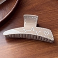 Detail view of khaki resin hair claw clip with white heart and pulse line patterns - Gray Scribble 11.6cm