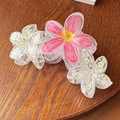 Detail view of large trapezoidal hair claw with peach pink and white acrylic flowers - Red Floral 11cm
