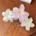 Detailed view of pink and white floral hair claws in matte acrylic on a wooden table - Light Pink Floral 11cm