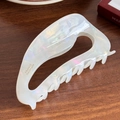 Extra large pearl white acetate claw clip with a sleek cutout design on a wooden desk - 11cm / Iridescent White