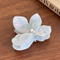 Iridescent white flower hair claw clip with crystal droplet on a wooden surface - Small / Metallic Blue