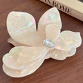 Iridescent pearl white floral hair claw clip with crystal droplet center on wood - Large / Iridescent Yellow