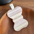 Pink and white striped acetate hair clip with silver duckbill clip on wooden background - Striped Pink