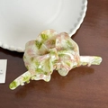 Close-up of pink and green marbled butterfly hair claw clip with acetate texture details - Pink-Green Marble