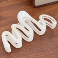 Creamy white wavy hair claw clip with pearlescent finish on a wooden background - Snake White