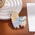 Detail of alpaca-shaped acetate hair clip with blue rhinestones on leather background - Duckbill Hair Clips / Dazzle Blue Yellow