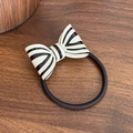 French vintage style hair tie with a black and white striped bow on a wooden surface - Beige Black Hair Tie