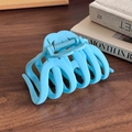 Matte light blue frosted hair claw clip with strong grip on dark wooden background - Blue