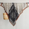 Detail of vintage paisley pattern on a large bohemian cotton-linen shawl with fringes - Black