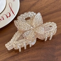 Elegant ivory butterfly hair claw clip with pink rhinestones on a wooden desk - Butterfly Bow-Champagne