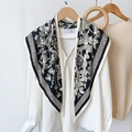 Detail of floral silk scarf with black polka dot border draped on a white lantern sleeve shirt - 87x130cm / Black
