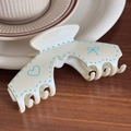 Beige resin claw clip featuring light blue hand-drawn heart and bow patterns - Off-White Arch Shape