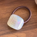 Brown elastic hair tie featuring a square aurora resin button with handmade text - Iridescent White