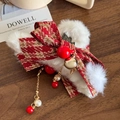 Plush white faux fur hair claw clip with red plaid bow and festive tassel charms - Christmas Style