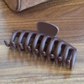 Matte dark coffee large shark clip for thick hair shown on a natural wood surface - Shark Clip-Dark Coffee