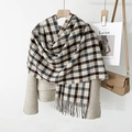 Detail of classic black and beige grid scarf featuring elegant tassel edges on a wool blazer - Beige