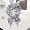 Elegant black and white paisley silk-like square scarf styled with decorative props - 68*68cm / White