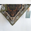 Close-up of vintage paisley pattern on olive green silk scarf with detailed printing - Green