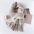Pink and white plaid cashmere scarf with fringes shown in a cozy aesthetic setting - Pink