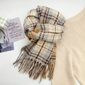 Plaid tassel scarf in beige, grey, and yellow over a cozy knit sweater - Blue White
