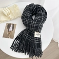 Elegante sciarpa a quadri neri e bianchi con morbide nappe e un'estetica minimalista - Nero