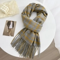 Winter plaid scarf in grey and yellow check pattern with tassel hem on white table - Yellow Blue