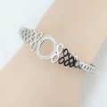 Bracciale rigido in argento con cerchio di diamanti e motivi ovali traforati - Argento