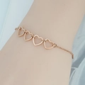 Bracciale minimalista in acciaio inossidabile oro rosa con quattro cuori cavi al polso - Oro rosa