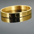 Polished gold stainless steel mantra cuff bracelet with religious engraving and mirror reflection - Gold