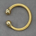 Punk style golden stainless steel twisted cable cuff bracelet with engraved floral end caps - Gold Color Bracelet