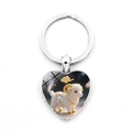 Detail of a silver heart-shaped keychain featuring a 3D cartoon sheep with gold accents - Goat (XSWX9284-8)