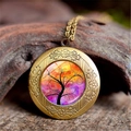 Detailed close-up of a bronze locket necklace featuring a vibrant tree of life glass dome - Orange Pink Art Tree Style (XHXL0009)