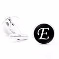 Detailed close-up of silver men's cufflinks featuring a black round disk with white letter E - Letter E