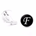 Detail view of silver round cufflinks featuring letter F with bullet back closure - Letter F