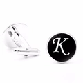 Detailed view of silver-plated cufflinks with black letter K design and T-bar fastening - Letter K
