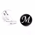 Detailed view of silver men's cufflinks featuring a black round base with a white letter M - Letter M