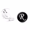 Detailed close-up of men's silver cufflinks with letter R on a black background - Letter R