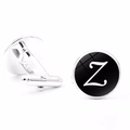Macro detail of silver cufflinks with black base and white letter Z engraved pattern - Letter Z