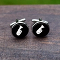 Macro shot of silver cufflinks with white tuba musical pattern on black background - Tuba Bass Horn Style