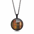 Detailed close-up of a circular vintage book spine pendant with a black alloy chain link - Black