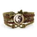 Dettaglio del bracciale in pelle multistrato con cupola in vetro lupo yin yang e farfalla - Marrone