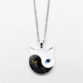 Yin Yang cat pendant necklace with black and white feline faces in cat ear frame - Silver