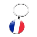 Detailed close-up of a French flag keychain with a polished glass dome and metal ring - France (ABXL1536)