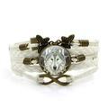 Retro multi-layer woven leather bracelet featuring Celtic wolf glass cabochon and butterfly charms - White