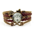 Retro multi-layer woven leather bracelet featuring Celtic wolf head glass gem and butterfly charm - Brown
