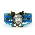 Braided blue leather bracelet with celtic wolf glass gem and bronze butterfly - Blue